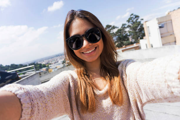 istock Young woman taking a selfie smiling at camera 1249402091