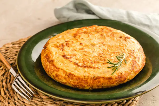Photo of Spanish omelette with potatoes and onion, typical Spanish cuisine. Tortilla espanola