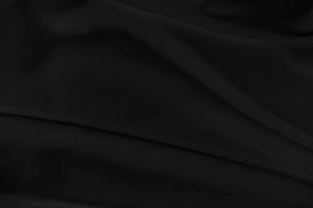 istock Black gray satin dark fabric texture luxurious shiny that is abstract silk cloth background with patterns soft waves blur beautiful. 1249404543