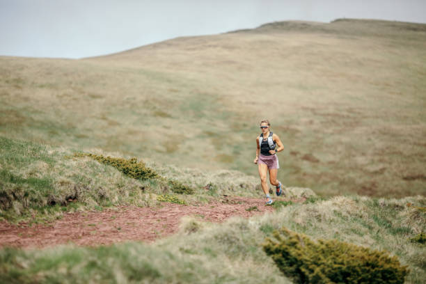 istock Young woman running on mountain 1249404590