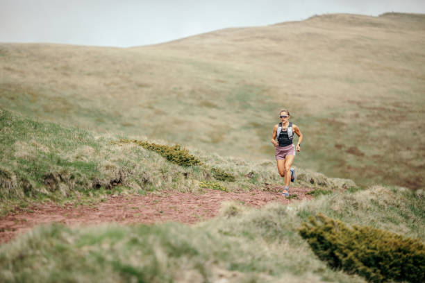 istock Young woman running on mountain 1249404611