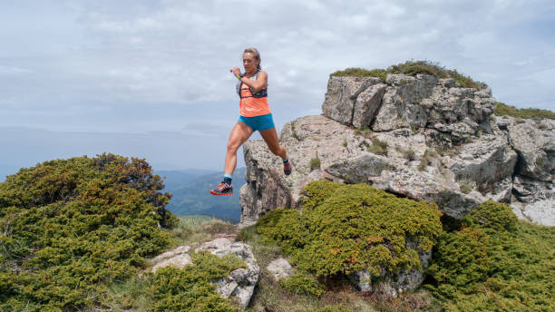 istock Young woman running on mountain 1249404872