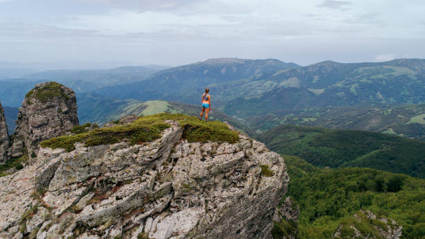 istock Young woman running on mountain 1249404920