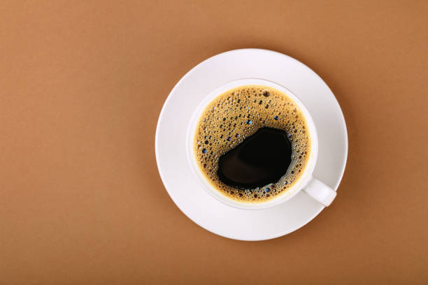 istock Cup of black coffee on white saucer 1249407550