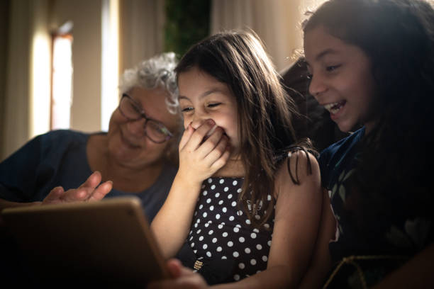 istock Grandmother and granddaughter using digital tablet at home 1249407592
