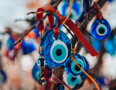 Colorful nazar boncugu or evileye charms hang from a tree in Cappadocia, Pigeon valley, Anatolia, Turkey