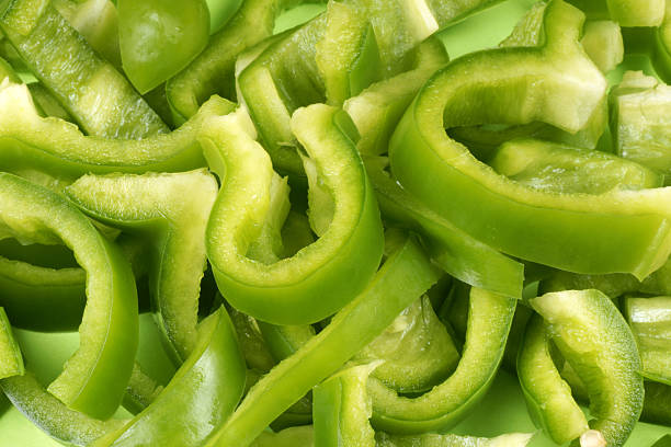 Thinly sliced up green bell peppers stock photo