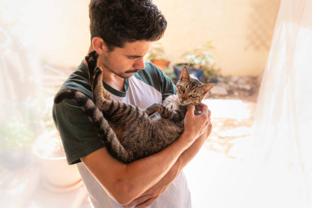 istock young man interacts with his pets in the garden under a mosquito net 1249415534