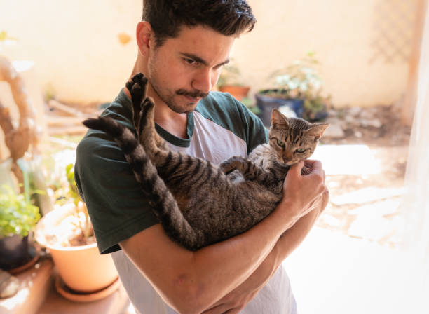 istock young man interacts with his pets in the garden under a mosquito net 1249415536