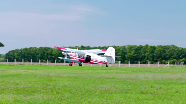 A small airplane lands on the runway.