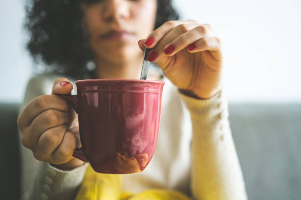 istock Woman stirring coffee 1249419344