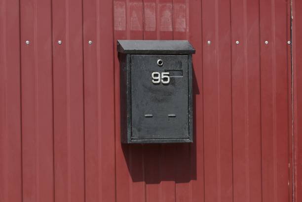 istock one black iron mail box hanging on a red metal fence wall 1249420216