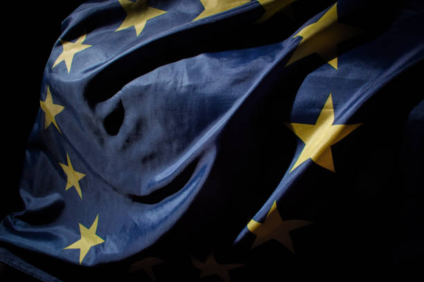Waving colorful European Union flag over black background