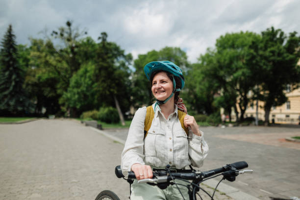 istock Smiling girl with casque on the bicycle 1249430403