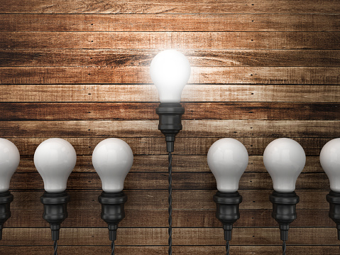 Light Bulbs on Wood Wall Background - 3D Rendering