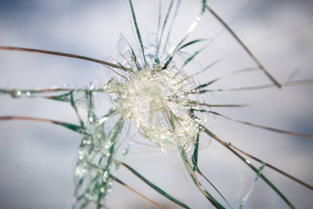 istock Broken Glass with Blue Sky and Clouds in Background. 1249442673