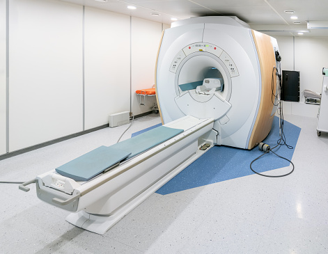 MRI - magnetic resonance imaging - scanner machine in hospital room, nobody inside.