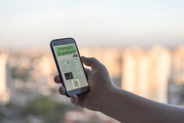 istock Adult hand using cell phone with job search application available - App in portuguese language 1249448718