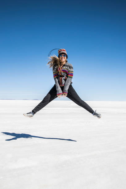 istock young woman jumping in the salt flats 1249450359