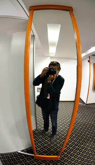 Photographer self portrait in the mirror, in the hotels hall