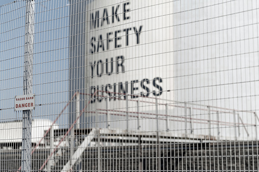 Health and safety slogan painted on the side of an oil storage tank at an oil refinery.  Belfast, Northern Ireland.