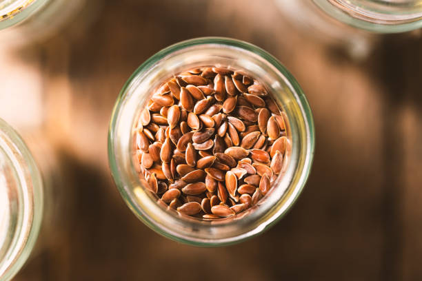 Flaxseed in glass jar stock photo