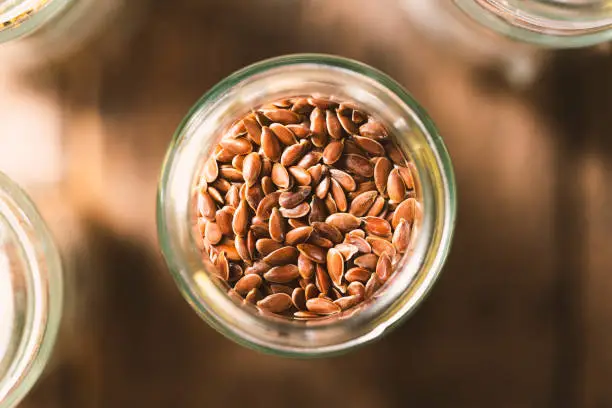 Flaxseed in glass jar.  Spices from directly above, selective focus.