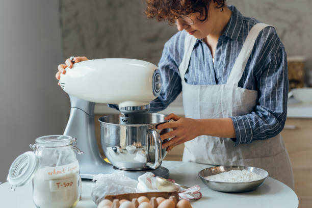 istock Happy Woman Using a Stand Mixer to Make Cookie Dough 1249455829