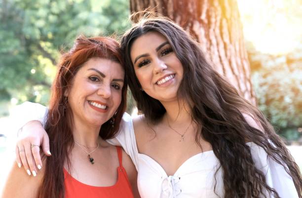 istock Hispanic mother and daughter posing looking at the camera smiling 1249456535