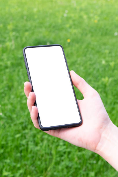 istock Woman holding modern smartphone with background, white mockup 1249456551