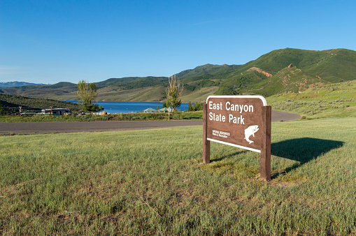 Morgan, Utah, USA - June 12, 2020: This shot shows the entrance sign to  East Canyon State Park, taken on a summer morning.  Overnight and day campers enjoying playing on the water and fishing in the mountain lake that makes up the park.