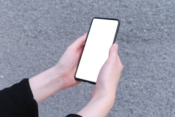 istock Woman holding modern smartphone with background, white mockup 1249456737