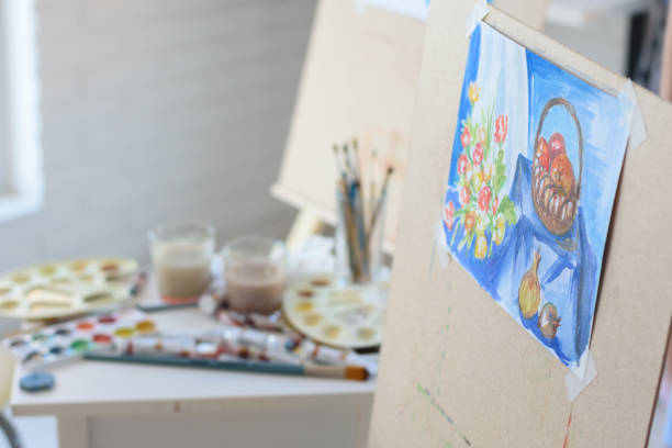 istock artist's workplace with an easel on which hangs still life 1249457594