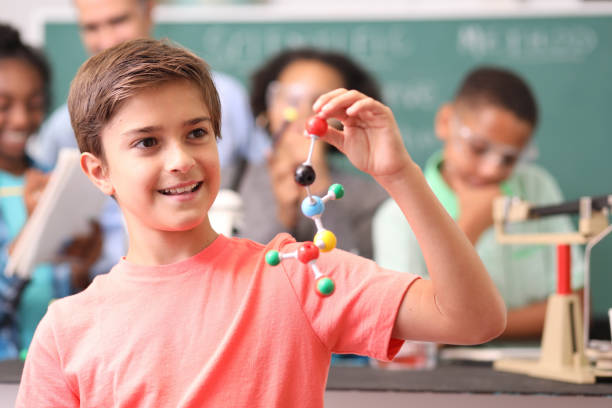 elementary school student conducts science experiments in classroom. - professor scientist chemistry teacher imagens e fotografias de stock