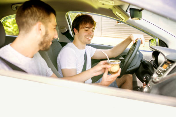 istock Two young men in a road trip driving a car and drinking yerba mate 1249461537