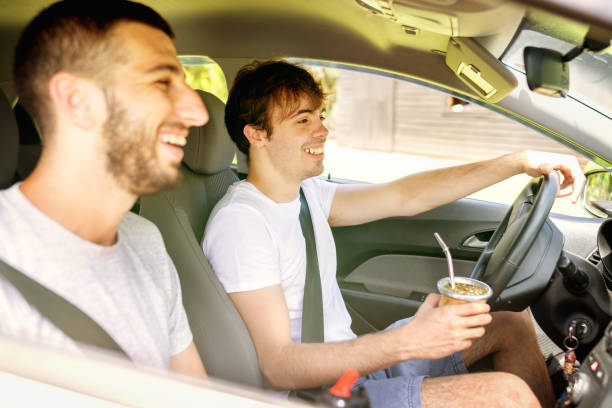istock Two young men in a road trip driving a car and drinking yerba mate 1249462090