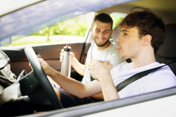istock Two young men in a road trip driving a car and drinking yerba mate 1249462163
