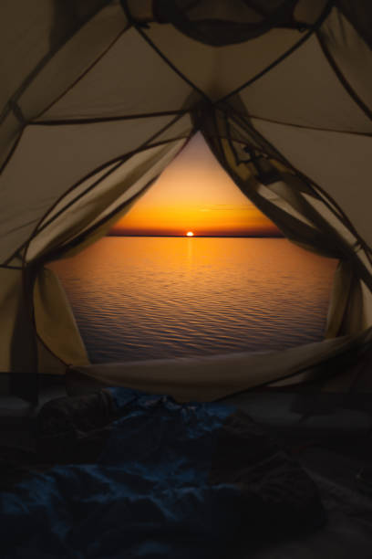 istock Sunrise over the sea through the tent 1249464908