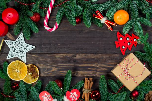 istock horizontal card Decorations for the Christmas tree, green branches on the table and space in the center of the frame holiday concept 1249466099
