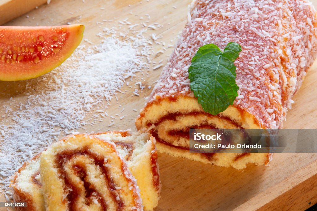 Bolo de Rolo (Swiss roll, Roll cake) typical Brazilian dessert, from the northeast region. Sliced "u200b"u200bcake roll with guava paste Bolo de Rolo (Swiss roll, Roll cake) typical Brazilian dessert, from the northeast region. Sliced "u200b"u200bcake roll with guava paste. Brazilian Food Stock Photo