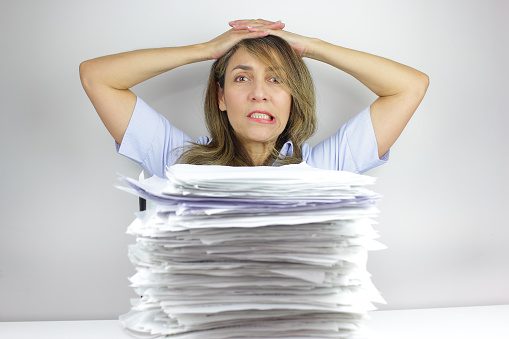 Business woman angry at all the paperwork