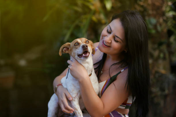 istock White woman playing with her dog pet 1249471420