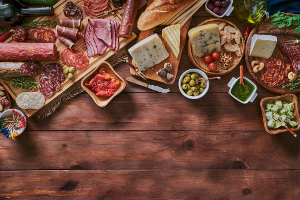 istock Tapas of cured ham and cheese delicious appetizer on rustic wood table with copy space 1249474721