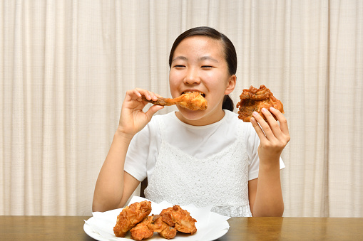 Japanese girl enjoys having fried chicken
