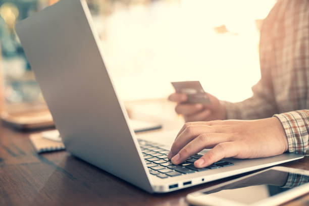 istock Working at home. Close-up image of young man working on laptop while 1249477396