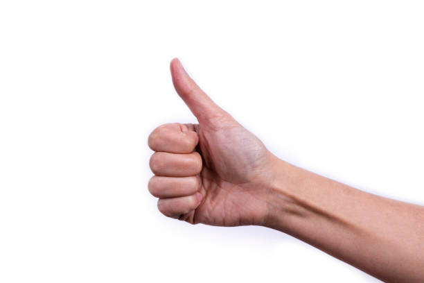 istock Female hand close-up on a white background. Thumbs up. 1249480978