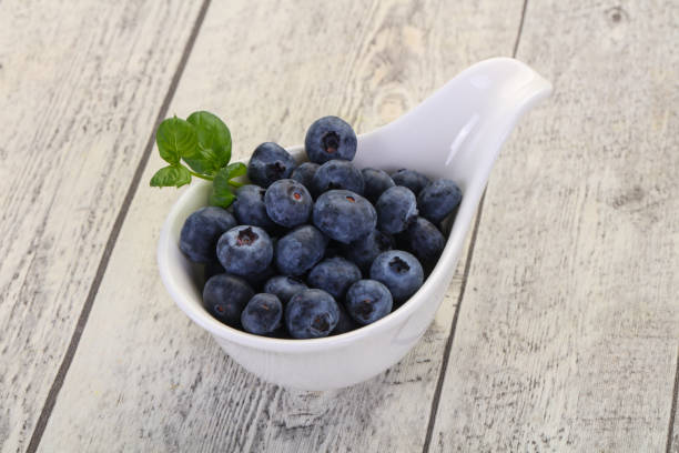 Blueberries in plastic on a colourful background as an example of sustainable recycling and healthy diet