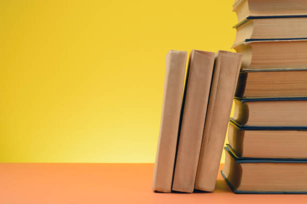 istock Vintage Books on Colored Paper Background. 1249496645