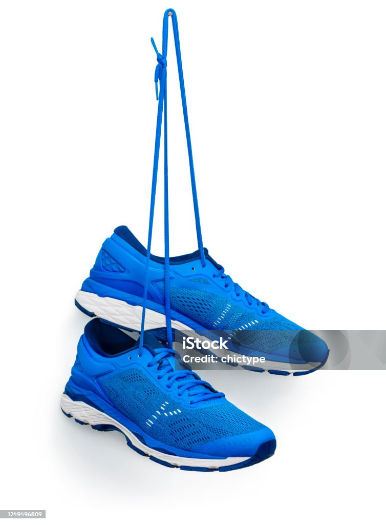 Running Shoes Hanging From A Hook A pair of blue running shoes hanging from a hook. 
Isolated on a white background. Sports Shoe Stock Photo