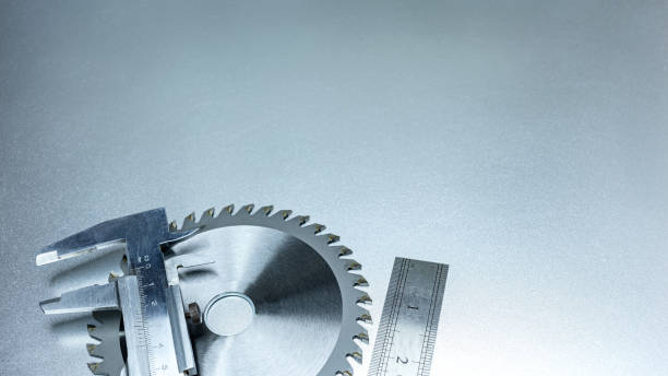 istock circular saw blade, rule and caliper on grey metal desk 1249497723